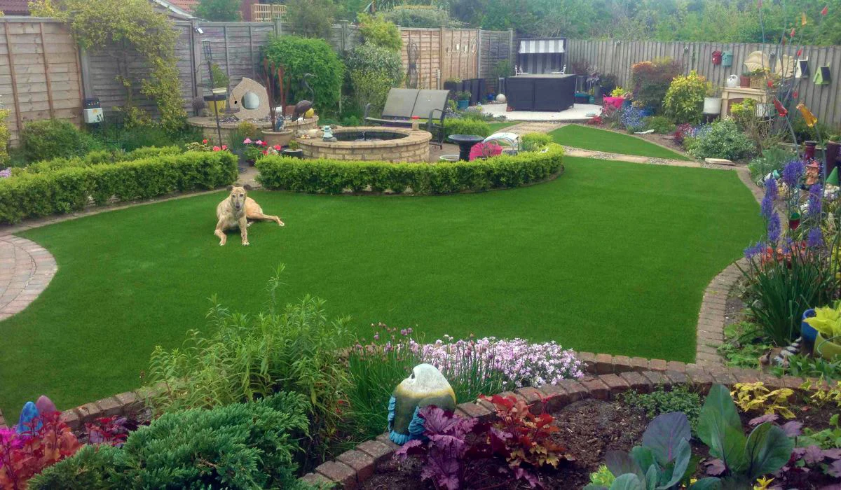 Backyard transformed into a pet-friendly oasis with non-toxic plants, shaded play areas, and secure fencing, designed to blend seamlessly with the natural surroundings.