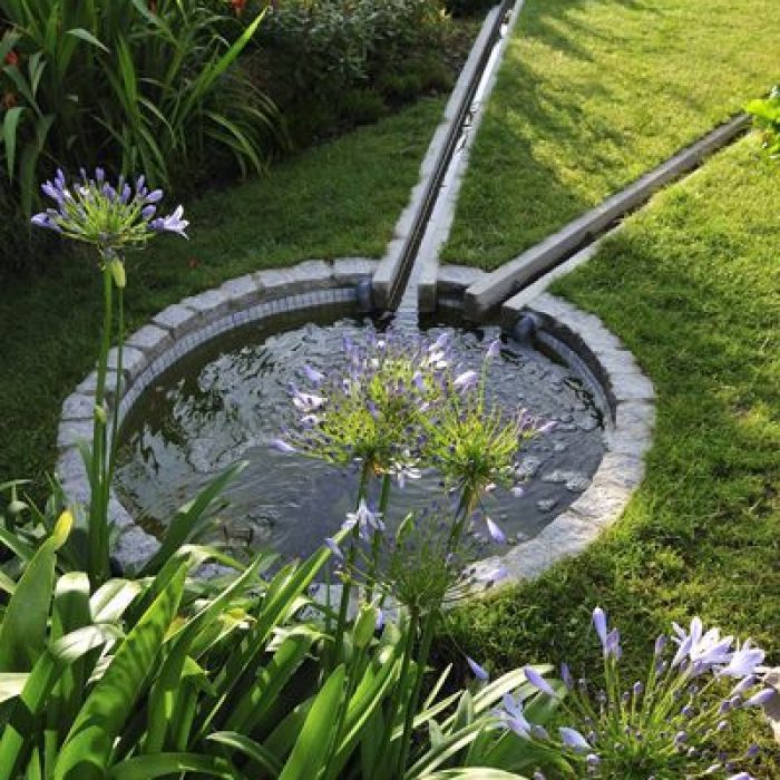 Gardener planting flowers in rich, nutrient-dense soil for healthy plant growth.